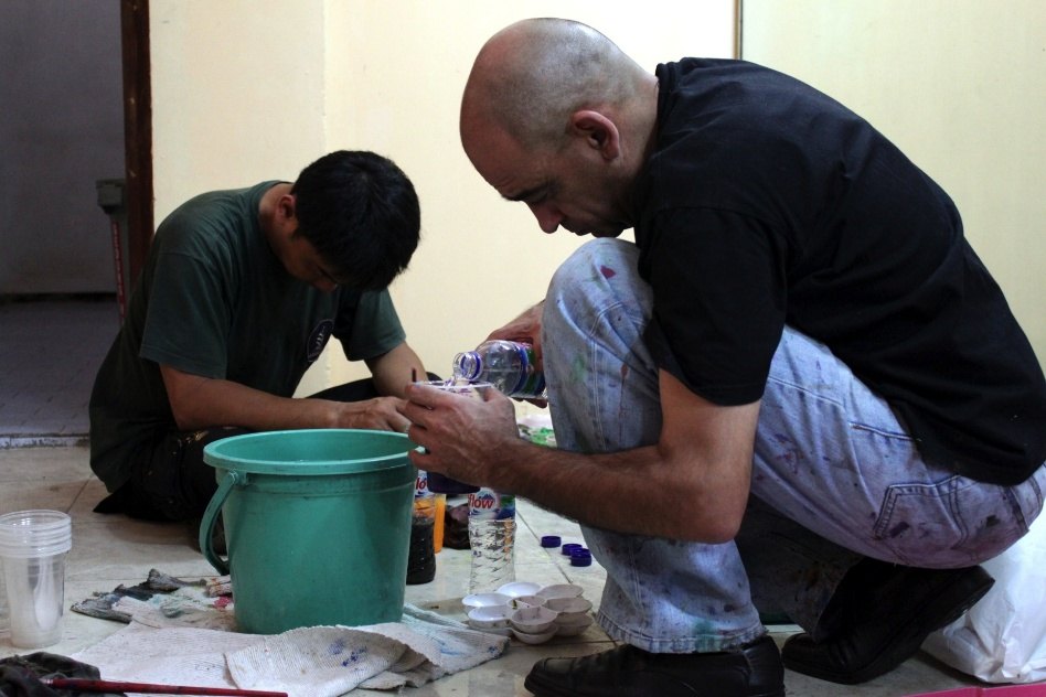 Mikhail and a helper preparing the paint